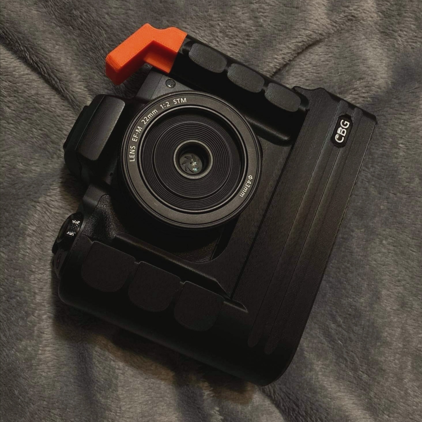 Our Extended Battery Grip for Canon EOS M50 with orange cold shoe